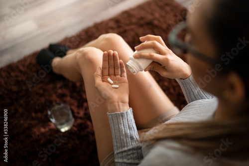Woman Addicted to Painkillers Holding Pills in Her Hand Palm photo
