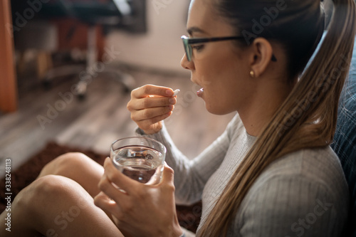 Young White Woman Swallowing Her Medical Treatment Pills With Water