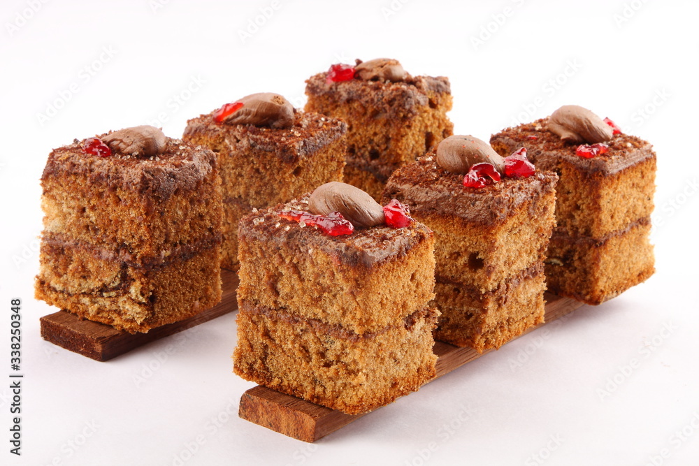 Oven fresh chocolate cream cake slices on a white background. Oven fresh chocolate cream cake slices on a white background.
