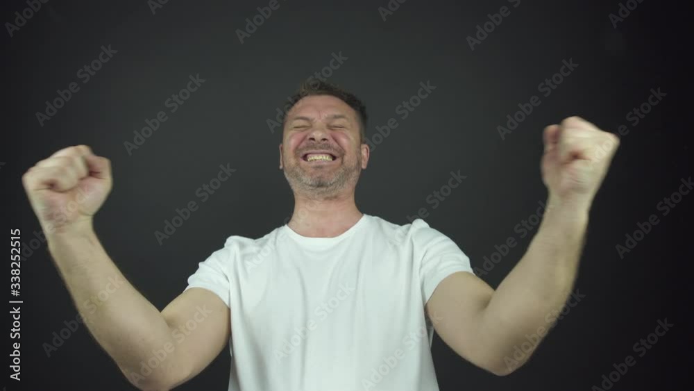 man with three-day beard in t-shirt laughs shaking hands man with three-day beard in t-shirt laughs shaking hands