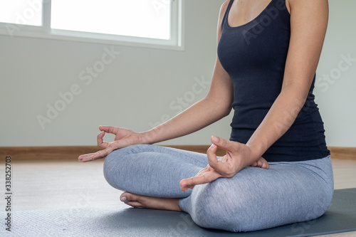 Fototapeta Naklejka Na Ścianę i Meble -  Women wearing exercise clothes yoga sitting posture calm relax in the house. healthy lifestyle concept.