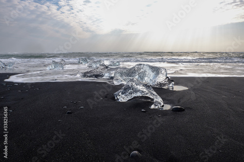 Ice floes and smaller chunks broken off larger icebergs tha thave floated out to the open ocean wash up on a black sand Iceland Beach © Jorge Moro