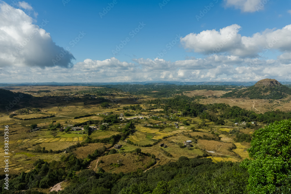 amazing landscape in the countryside with a stream flowing by and a vista view of the clouds and the mountains