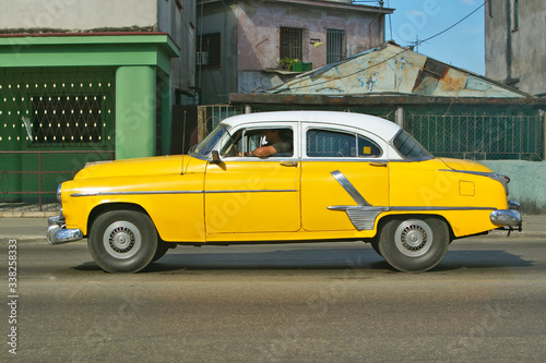 Yellow Pontiac driving through the streets of Havana  Cuba