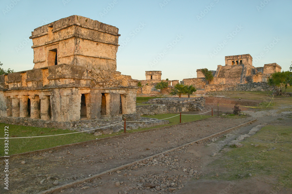 Temple of the Frescoes at the Mayan ruins of Ruinas de Tulum (Tulum Ruins). El Castillo is pictured in the background, in Quintana Roo,Yucatan Peninsula, Mexico.
