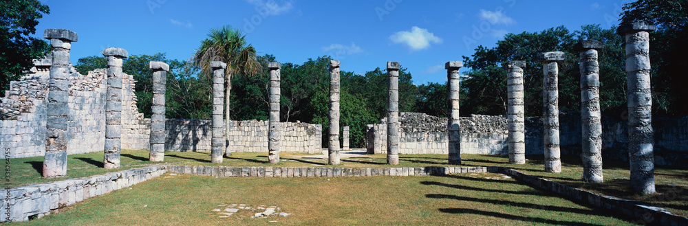 A panoramic view of columns surround grassy courtyard for ballgames at Chichen Itza, Mayan Ruins in the Yucatan Peninsula, Mexico