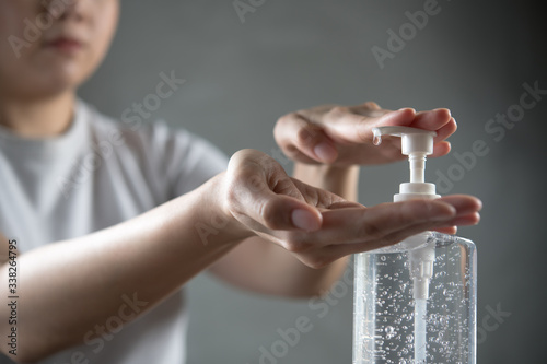 Person washing hands with alcohol gel for disinfection hygiene and protection against CORONAVIRUS (COVID-19) and other diseases