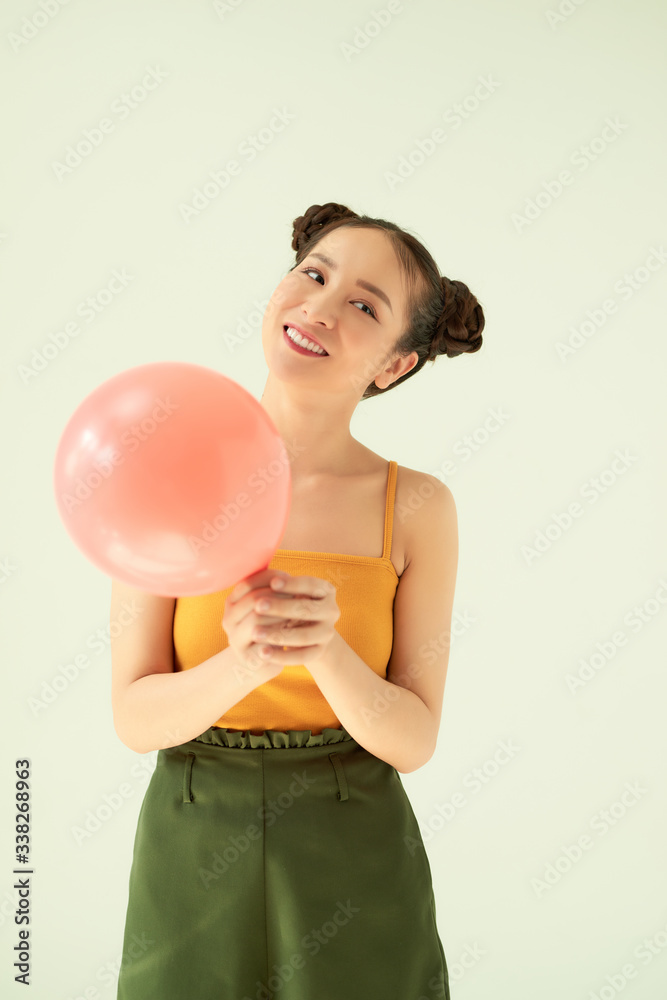 Portrait of attractive lovely gilr holding air balloon against light background. Portrait of attractive lovely gilr holding air balloon against light background.