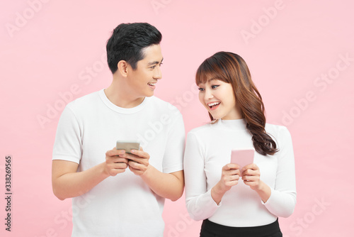 Cheerful young couple watching the smart phone