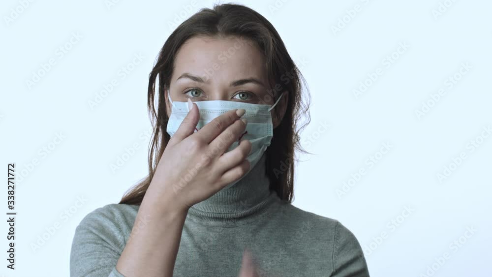 Girl puts on medical mask with inscription 2019-ncov. Coronavirus outbreak Girl puts on medical mask with inscription 2019-ncov. Coronavirus outbreak