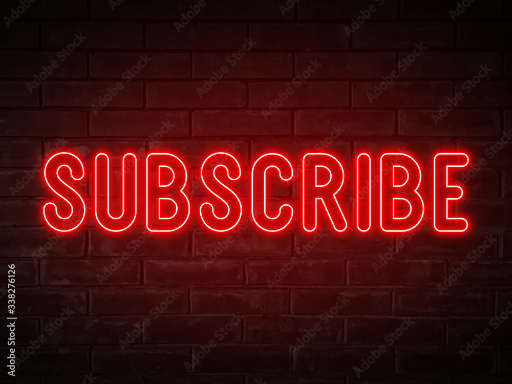Subscribe - red neon light word on brick wall background Subscribe - red neon light word on brick wall background