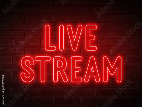 Live stream - red neon light word on brick wall background 