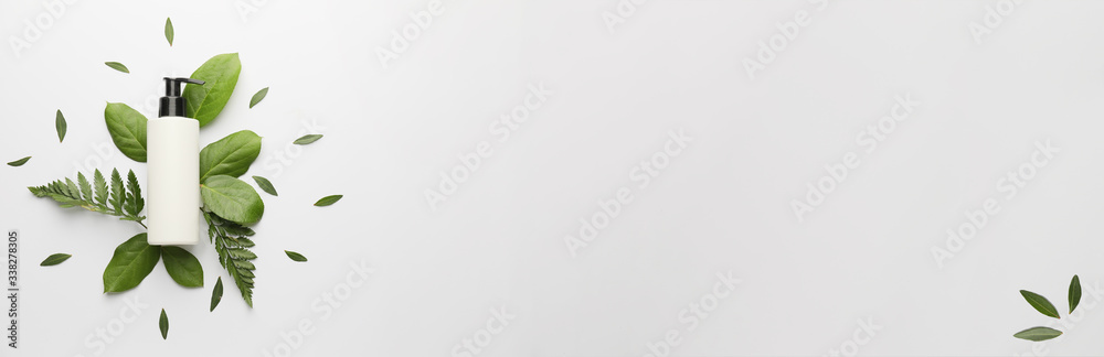 Cosmetic product in bottle on light background with space for text