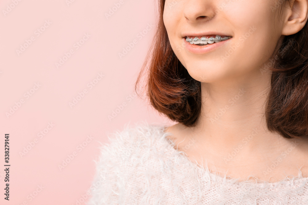 Teenage girl with dental braces on color background, closeup Teenage girl with dental braces on color background, closeup