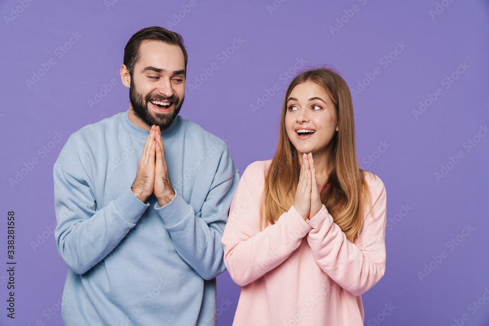 Optimistic loving couple showing please hopeful gesture. Optimistic loving couple showing please hopeful gesture.