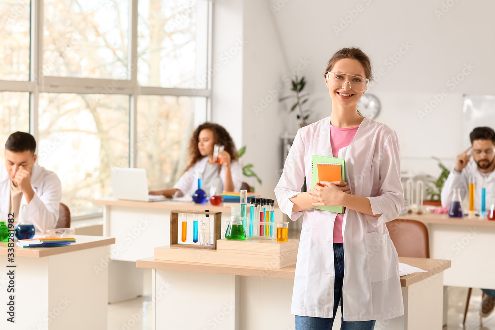 Young woman at chemistry lesson in classroom Young woman at chemistry lesson in classroom