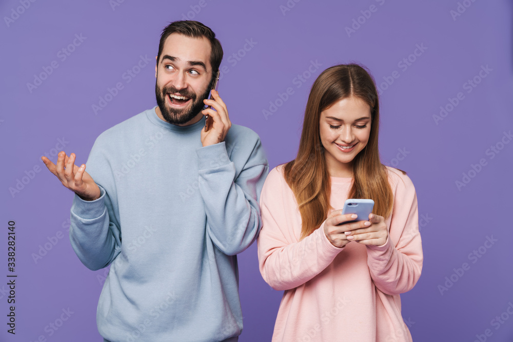 Optimistic loving couple talking by mobile phones chatting. Optimistic loving couple talking by mobile phones chatting.