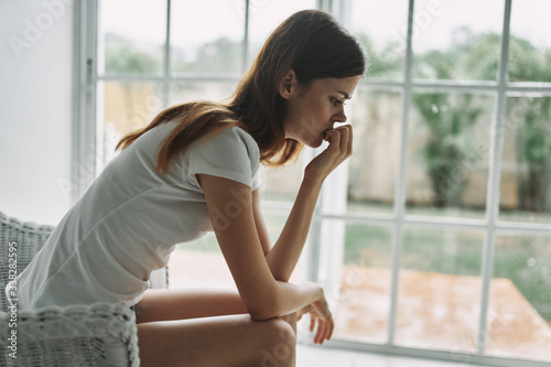 Free Download young woman sitting on the window sill - GFXLoad
