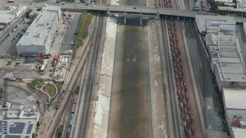 AERIAL: Los Angeles River with Water Tilt up revealing Highway and LA Cityscape on Cloudy Overcast Sky AERIAL: Los Angeles River with Water Tilt up revealing Highway and LA Cityscape on Cloudy Overcast Sky