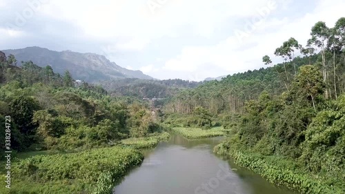 Fly over a River surrounded by trees photo