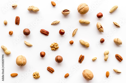 Nuts background - with almond, macadamia, walnut - on white table top-down