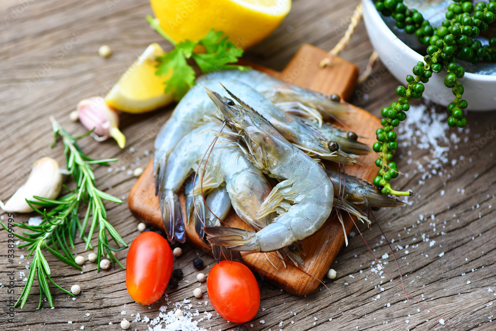fresh shrimp on wooden cutting board with ingredients herb and spices for cooking seafood - raw shrimps prawns fresh shrimp on wooden cutting board with ingredients herb and spices for cooking seafood - raw shrimps prawns