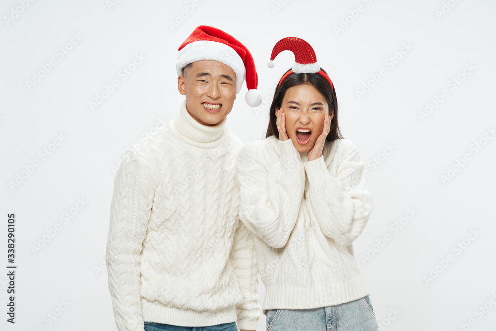 happy couple in christmas hats happy couple in christmas hats