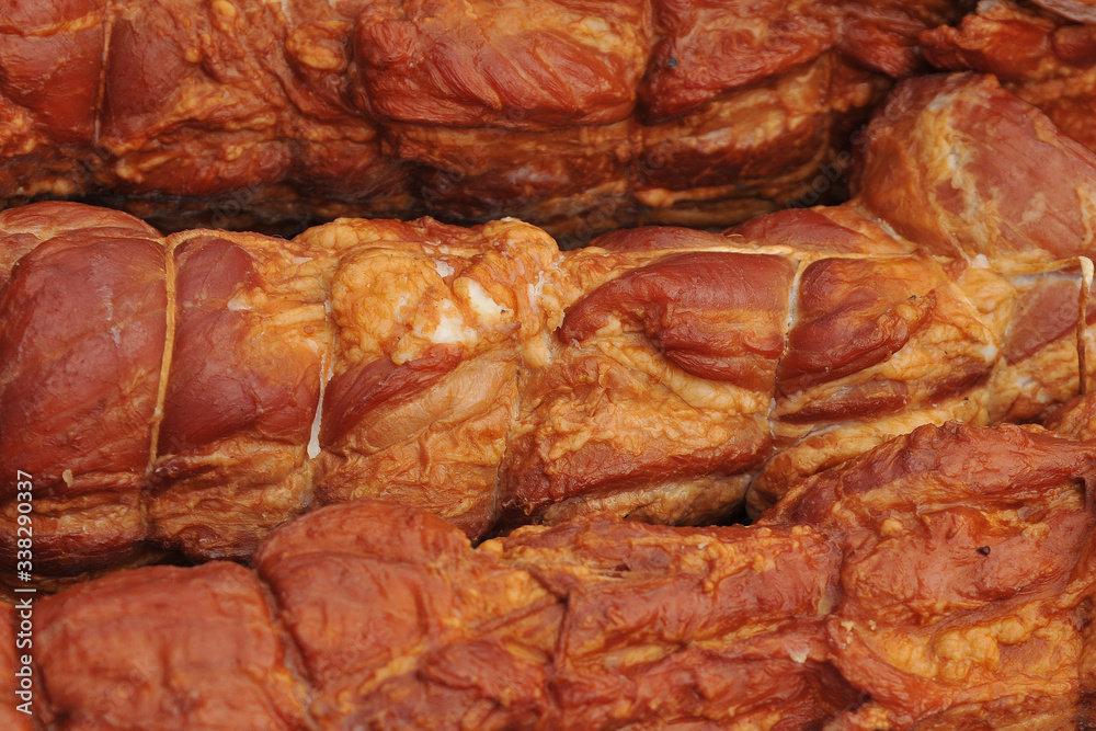 A large pieces of smoked bacon from pork. Smoked ham. Selective focus. A large pieces of smoked bacon from pork. Smoked ham. Selective focus.