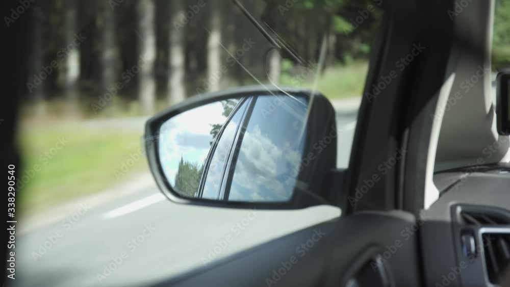 Looking at side mirror through car window while driving in norway Looking at side mirror through car window while driving in norway