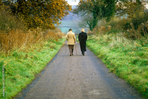 Fototapeta Naklejka Na Ścianę i Meble -  Two Women Walking in the English countryside