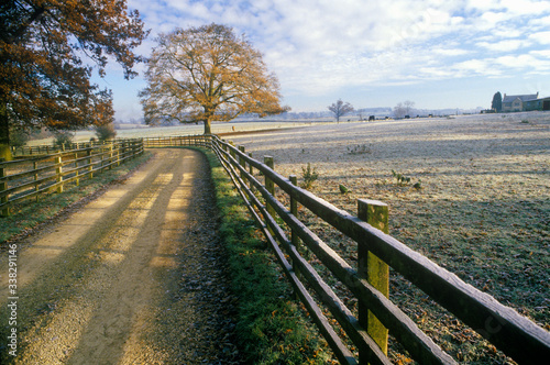 Morning view of a country road and wood fence in Upper Brails  England