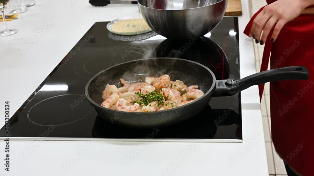 the cook is cooking langoustines. cook in the kitchen. wild shrimp. the cook is cooking langoustines. cook in the kitchen. wild shrimp.