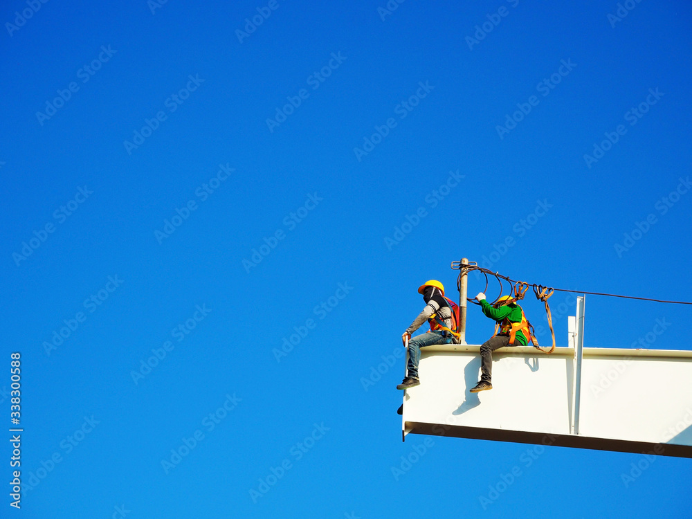 Man Working on the Working at height on construction site with blue sky Man Working on the Working at height on construction site with blue sky