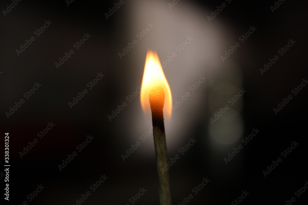 burning match on black background burning match on black background