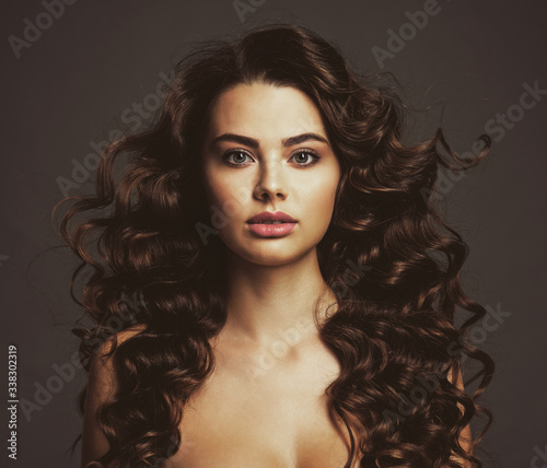 Beautiful young woman with long curly brown hair