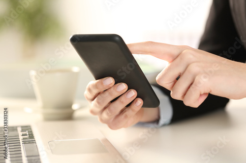 Executive woman hands checking phone at office