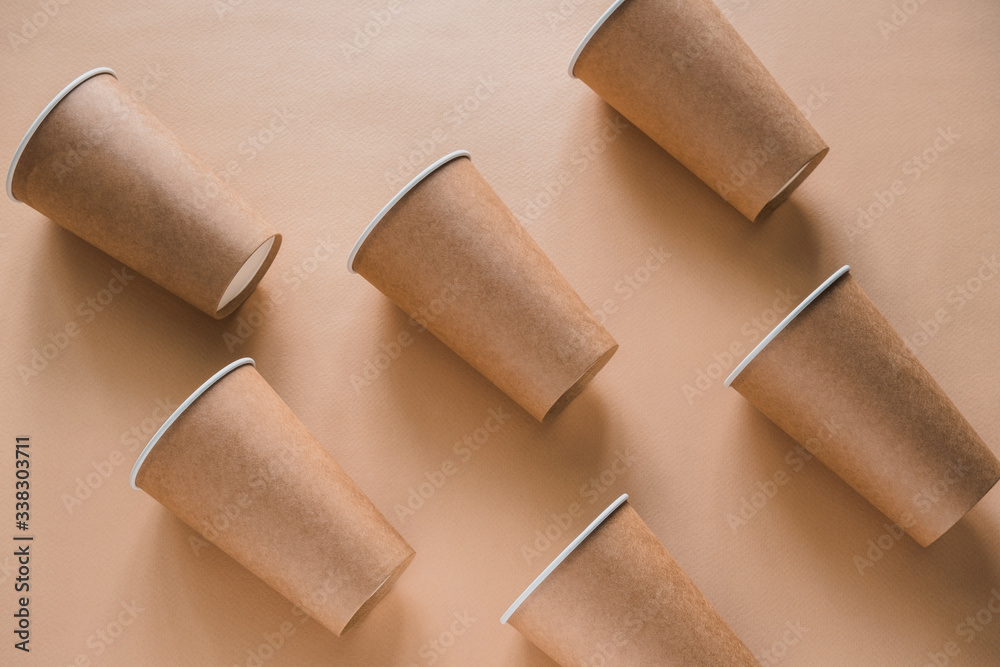 disposable paper biodegradable cups pattern on a beige background disposable paper biodegradable cups pattern on a beige background
