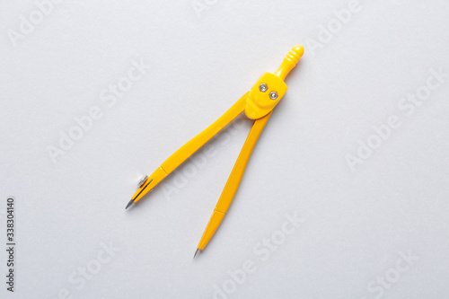 Fotografi Pair of compasses on grey background