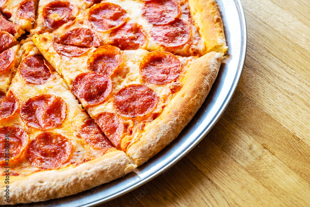 pepperoni pizza on the wooden background pepperoni pizza on the wooden background