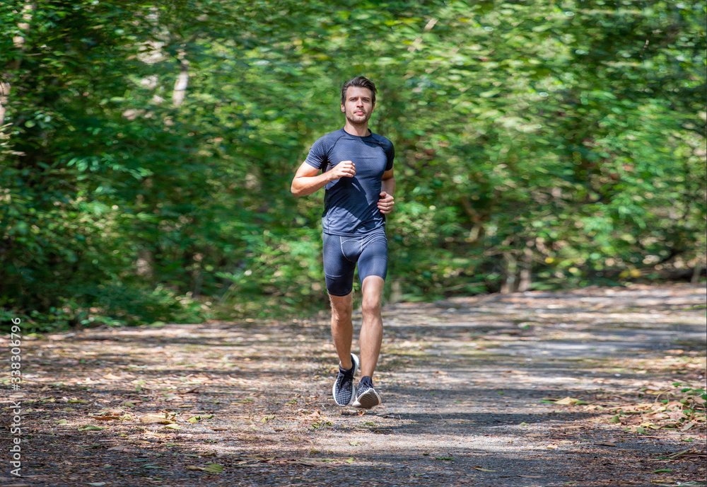 sport young man running in the forest . runner exercise in nature Healthy lifestyle . training and workout sport young man running in the forest . runner exercise in nature Healthy lifestyle . training and workout