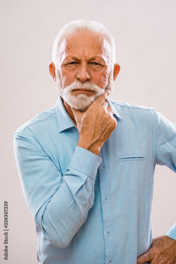 Portrait of pensive and serious senior man. Portrait of pensive and serious senior man.