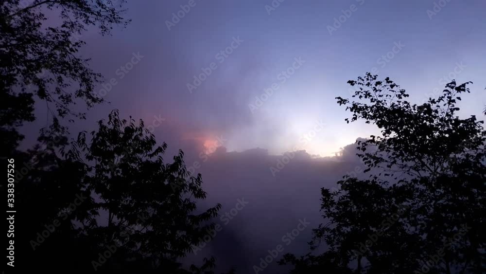 Dramatic Timelapse of Moving clouds on Himalayan landscape.Backlit sunset scene with colourful sky in blue hour.Haze and mist moving in the frame. Dramatic Timelapse of Moving clouds on Himalayan landscape.Backlit sunset scene with colourful sky in blue hour.Haze and mist moving in the frame.