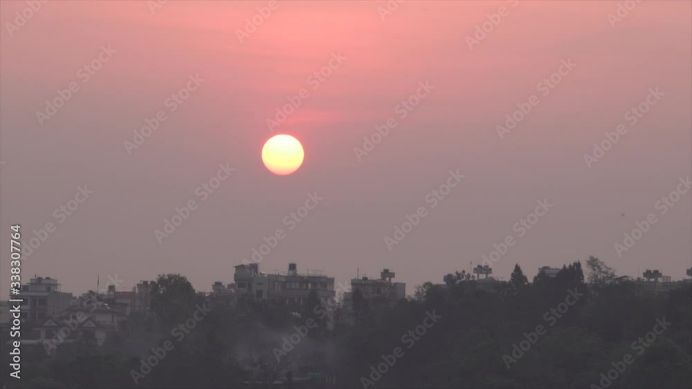 The morning sun rising over the rooftops of the houses in Kathmandu. The morning sun rising over the rooftops of the houses in Kathmandu.