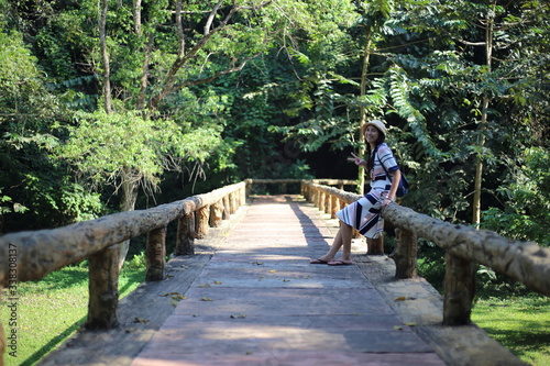 A woman sitting on a bridge at Phu Sang National Park, Phayao, Thailand