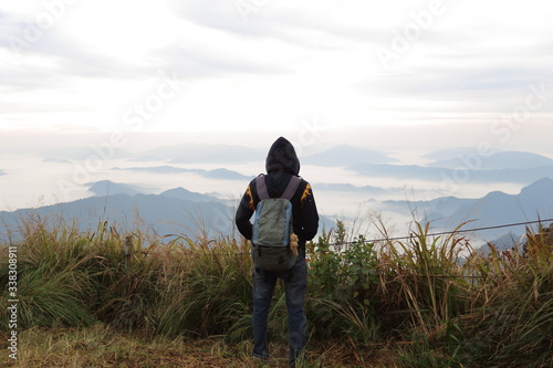 A man standing in the view at Phu Chi Fa National Park, Chiang Rai, Thailand