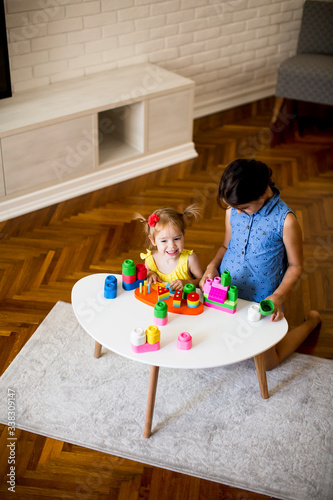 Two little girls play with ...