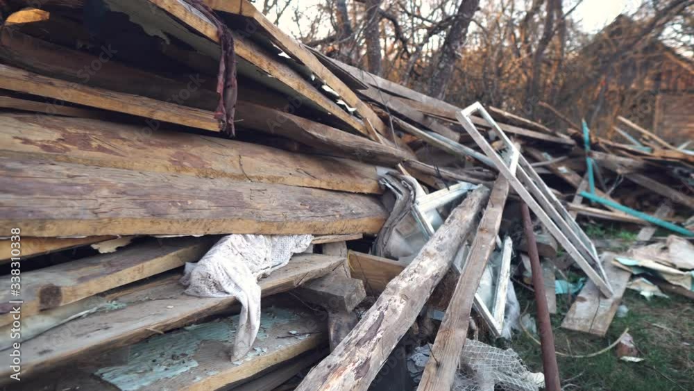 Environmental pollution by garbage.Destroyed house.Construction waste. Broken window.The house is being demolished. Poverty and ruin.