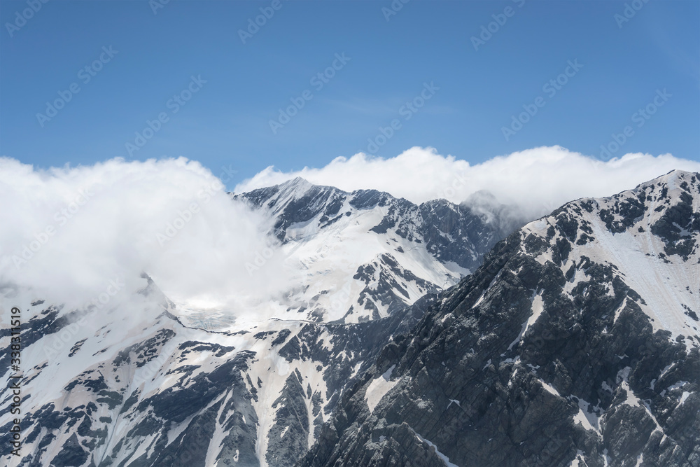 clouds cover Barron saddle at mt. Sealy range,  New Zealand