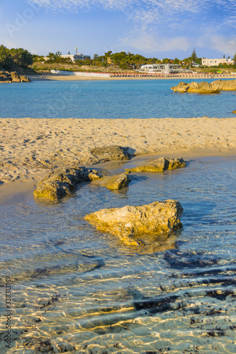 The most beautiful sandy beaches of Apulia: Marina di Pulsano (Italy). The coast is characterized by a alternation of sandy coves and jagged cliffs overlooking a truly clear and crystalline sea. photo