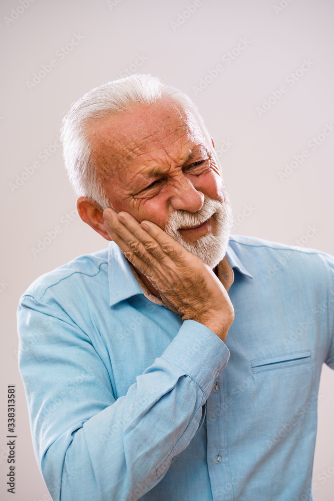 Portrait of senior man who is having toothache. Portrait of senior man who is having toothache.